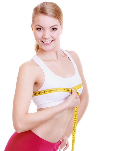 Fitness girl sporty woman measuring her bust size isolated - Foto, imagen