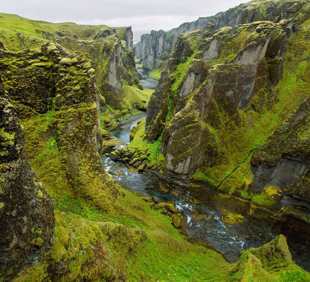 Canyon leading to the Icelandic waterfalls. Canyon with river and high cliffs - Fotó, kép