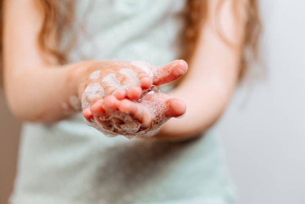 Dětské ruce v mýdlové pěně. Ochrana zdraví během propuknutí viru chřipky, epidemie a infekčních chorob - Fotografie, Obrázek