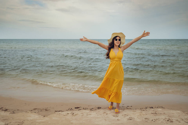 freedom woman with arms raised on the sea beach with wind blow - Foto, Bild