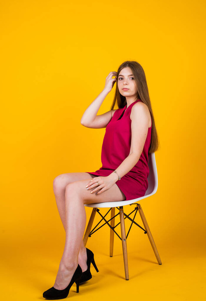 kid beauty standards. fashion and beauty. express real emotions. happy kid casual style. happy childhood. teenage child in stylish dress. smiling girl relax sit on chair. Shoes designed for living - Φωτογραφία, εικόνα