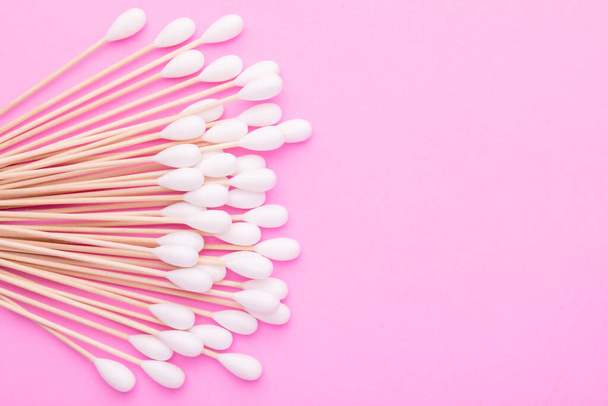 Top view cotton bud for cleaning the ears on pink background - Photo, Image