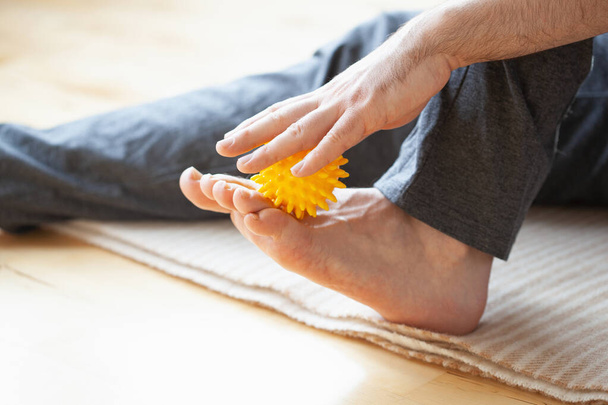 man doing flatfoot correction self massage at home - Photo, Image