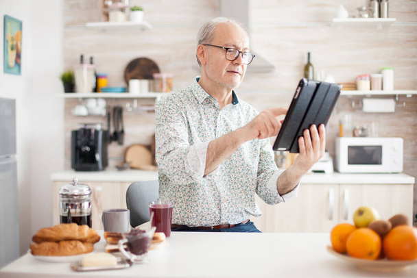 Elderly person with portable tablet PC - Photo, Image