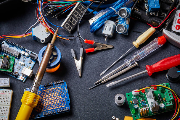 electronic board and tool repairs on black background - Photo, Image