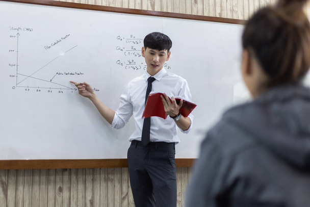 Math or physical teacher is working on teaching high school students in the classroom, opening of the new semester of students, Student education, Happy teaching concept - Photo, Image