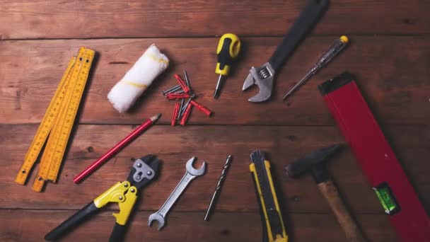 home improvement and repair concept - work tools and objects on wooden table background. top view copy space stop motion animation - Footage, Video