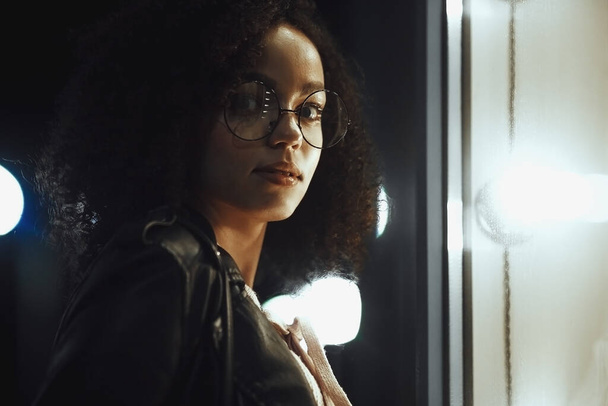 Portrait of young cute curly afro american girl. Night city lights. Neon illumination - Фото, зображення