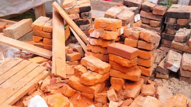 piles of brick, Red brick for building houses. Many used wall bricks laid on a pile - Footage, Video