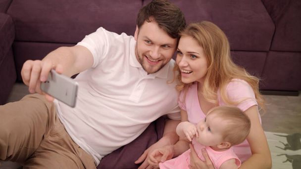 Self photo of happy family with little baby. Togetherness family portrait - Foto, afbeelding