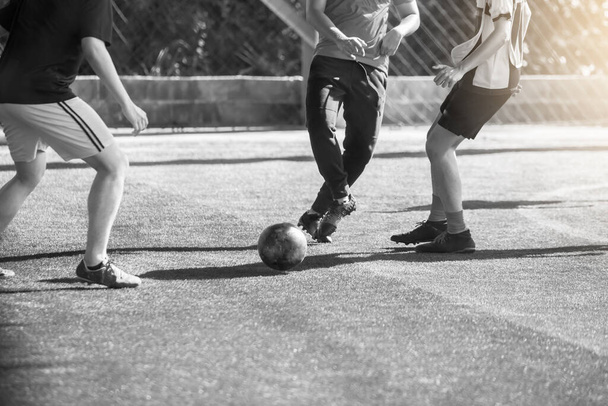 black and white sport picture. Selective focus to soccer player control and shoot ball to goal with goalkeeper. Soccer players fighting with goalkeeper. - Foto, Bild