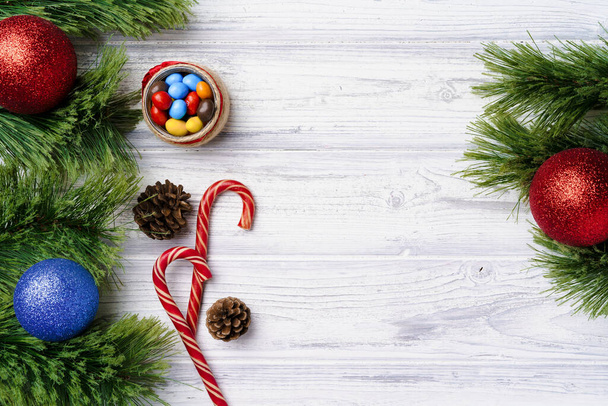 Festive background with candy canes and Christmas baubles - Фото, изображение