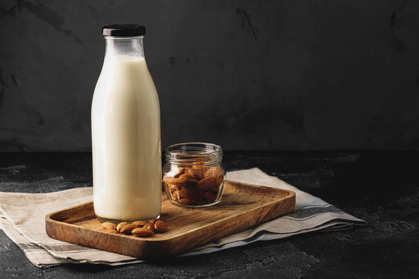 Almond milk with almond nuts in glass - 写真・画像