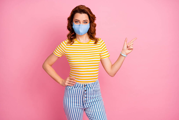 Portrait of her she nice attractive healthy wavy-haired girl wearing safety textile blue mask demonstrating copy space stop influenza vaccine contamination isolated pink pastel color background - Фото, изображение