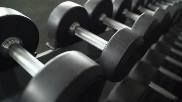 dolly shot, dumbbells are neatly arranged in the gym - Footage, Video