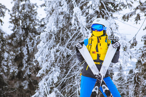 female in bright colored ski outfit snowed trees on background winter vacation - Photo, Image