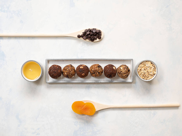 Healthy energy balls with oatmeal, agave syrup, cocoa, and chia seeds on a white background. Copy space. Top view. - Photo, Image