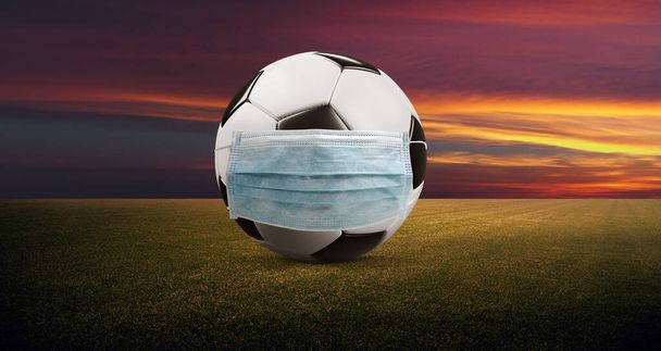 Euro soccer cancellation event concept. Ball with coronavirus mask - Фото, изображение