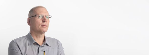 sad pensive man in spectacles glasses in sudio, white background, copy space, banner - Photo, Image