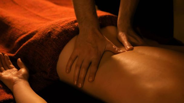 Masseur doing back massage for female client in spa center - Photo, Image