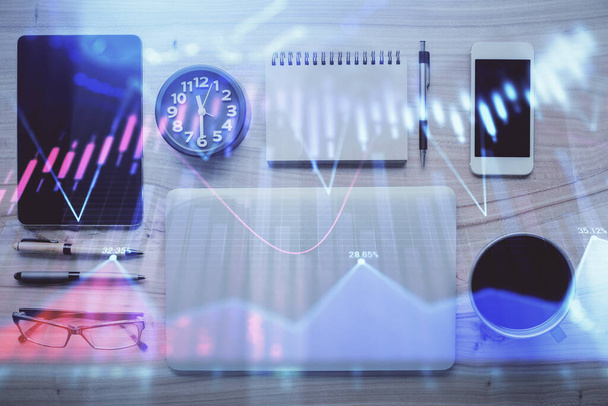 Double exposure of forex graph hologram over desktop with phone. Top view. Mobile trade platform concept. - 写真・画像