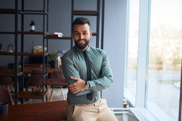 portrait of confident middle eastern young businessman standing in office - Fotó, kép