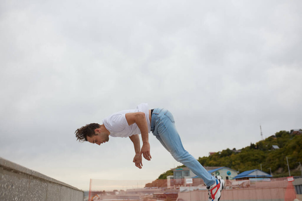 young man going to fall during performing a stunt - Фото, зображення