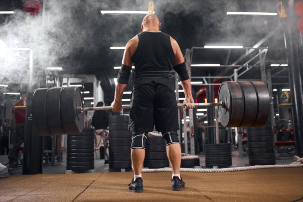 Active powerlifter in white smoke - Photo, Image