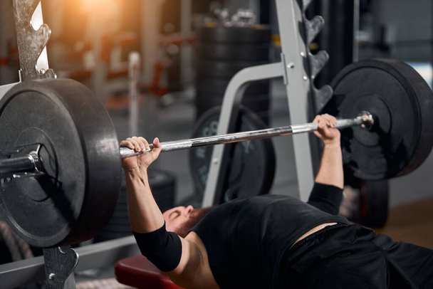 Man focused on lifting barbell - Photo, Image