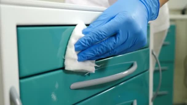 抗菌アルコールナプキンでベッドサイドテーブルを拭く.患者のための歯科キャビネットの準備。近代歯科での洗浄と消毒。滅菌と消毒。4 kビデオ - 映像、動画