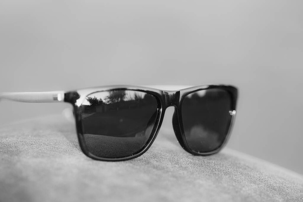 Modelo de gafas de sol clásicas con lentes negras de primer plano. Enfoque selectivo - Foto, Imagen