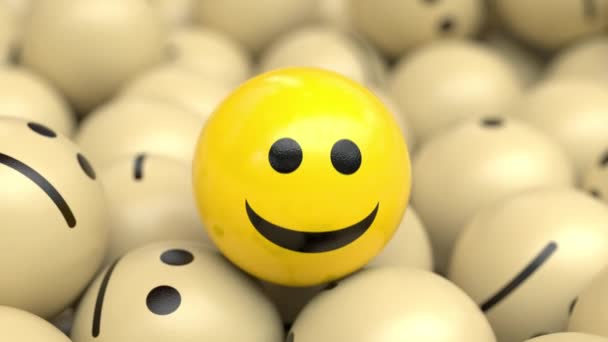 Fröhlich optimistischer Ball nickt und lächelt auf einem Haufen trauriger Bälle. - Filmmaterial, Video
