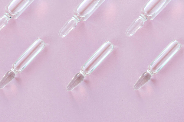 medical glass ampoules on a pink background - Fotografie, Obrázek