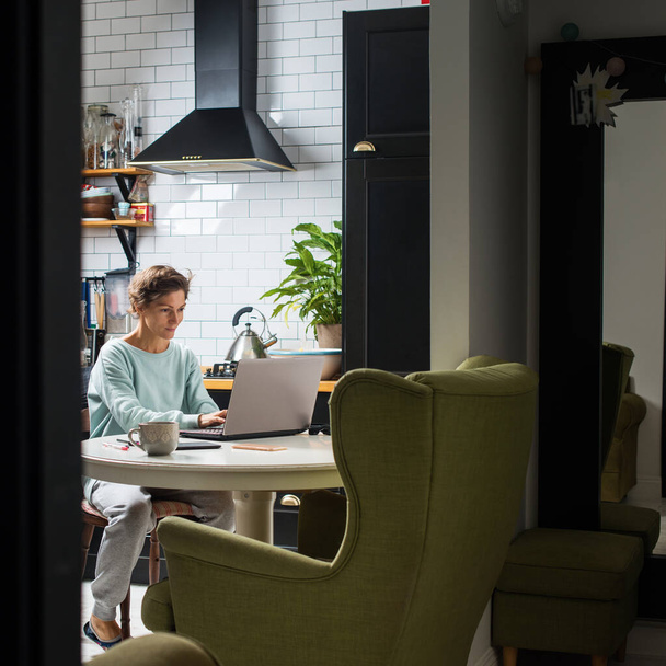 Stay at home concept. Young beautiful woman working at her home office online Communication computer internet laptop Businesswoman entrepreneur organized home-based job distant location. interior - 写真・画像