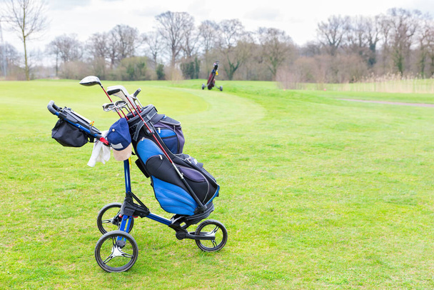 Golfwagen steht auf grünem europäischem Golfplatz - Foto, Bild