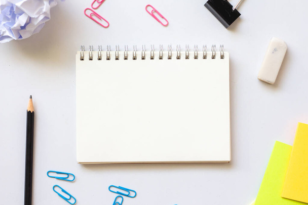 Blank notebook with paper clip on white background.minimal style. - 写真・画像