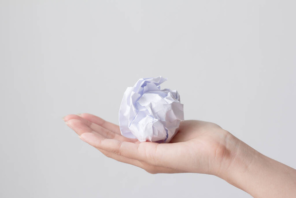 Crumpled paper ball on woman hand. - Foto, immagini