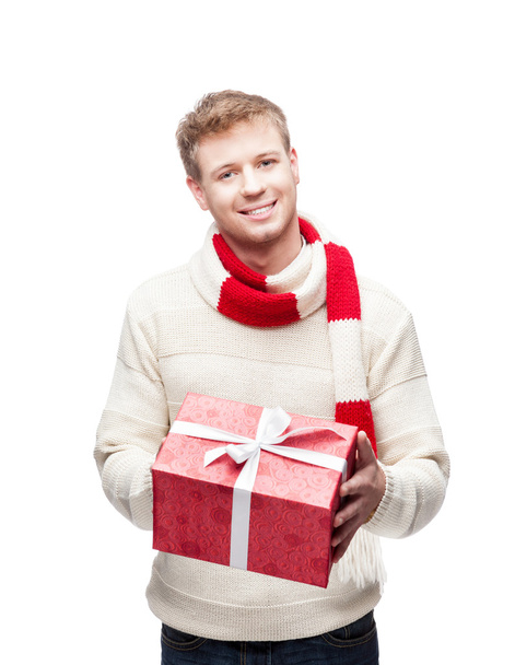 attractive young man holding red gift - Фото, изображение