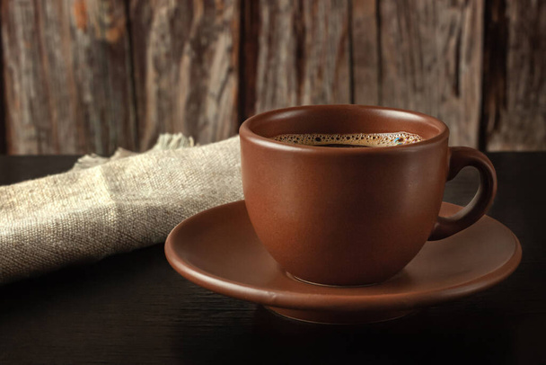 Cup of freshly brewed coffee on dark background - 写真・画像