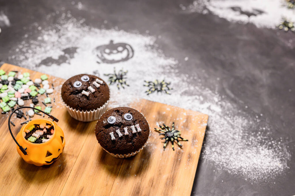 Cooking Halloween cake festive at home. Homemade bake ingredients with flour on dark background with copy space for text. - 写真・画像