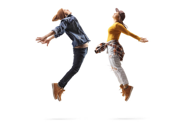 Full length profile shot of a male and female dancers jumping isolated on white background - Φωτογραφία, εικόνα