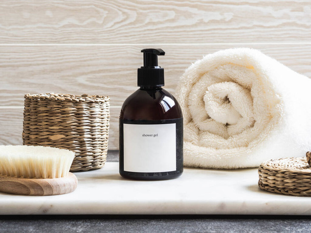 Mockup for bathing products in the bathroom, spa shampoo, shower gel, liquid soap with a towel beside and various accessories - Φωτογραφία, εικόνα