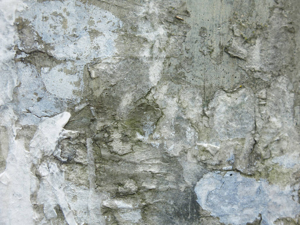 dirty rough concrete surface with scratches and scraps of ads, brutal and harsh background - Foto, afbeelding
