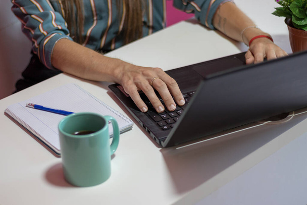 Woman teleworking with her laptop - Photo, Image