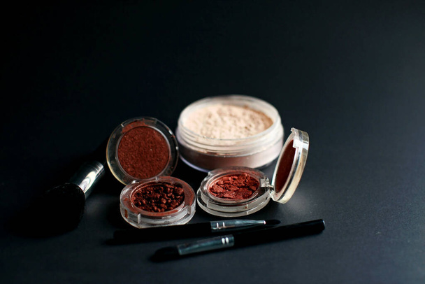 Cosmetic make-up on black background - Photo, Image