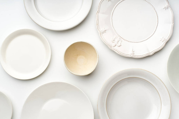 Flat lay with set of white ceramic plates, Kitchen tableware concept, top view - Zdjęcie, obraz