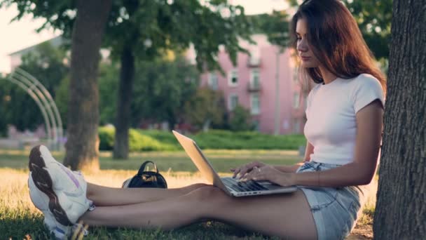 Girl teenager uses a laptop. - Video, Çekim