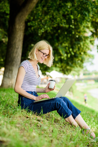 Girl laptop outdoors. Why employees need to work outdoors. Being outdoors exposes workers to fresher air and environmental variations making happy and healthy on physical and emotional level - Foto, Bild
