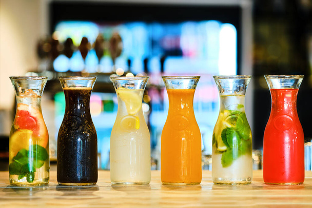 Assortment of cold lemonade on the barcounter (soft focus photo with shallow depth of field) - Foto, Imagem