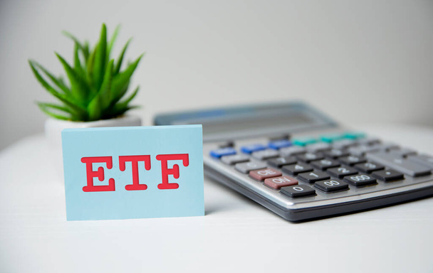 ETF, Exchange Traded Fund concept, cube wooden block with alphabet building the word ETF at the center - Фото, изображение